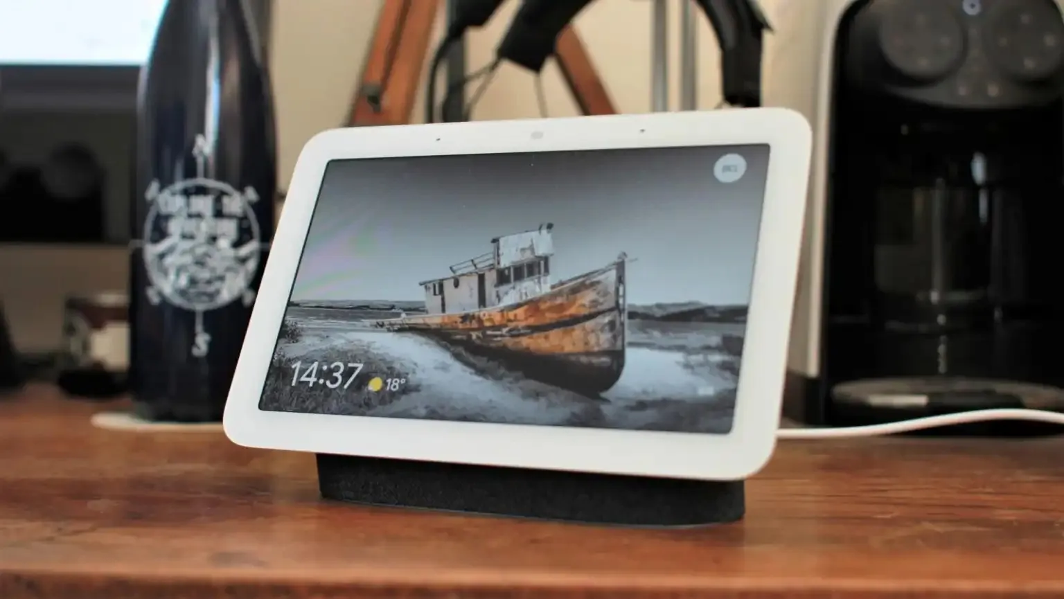 Apple HomePad smart display with sleek metal base and 6 inch screen on a kitchen countertop